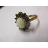A 9ct gold opal and garnet ring size J, total weight 2.9g Location: Cab