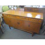 A mid 20th century retro G-plan teak sideboard designed by Victor Wilkins having four drawers