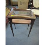 A reproduction inlaid rosewood finished display table with a hinge, glazed top and sides, on