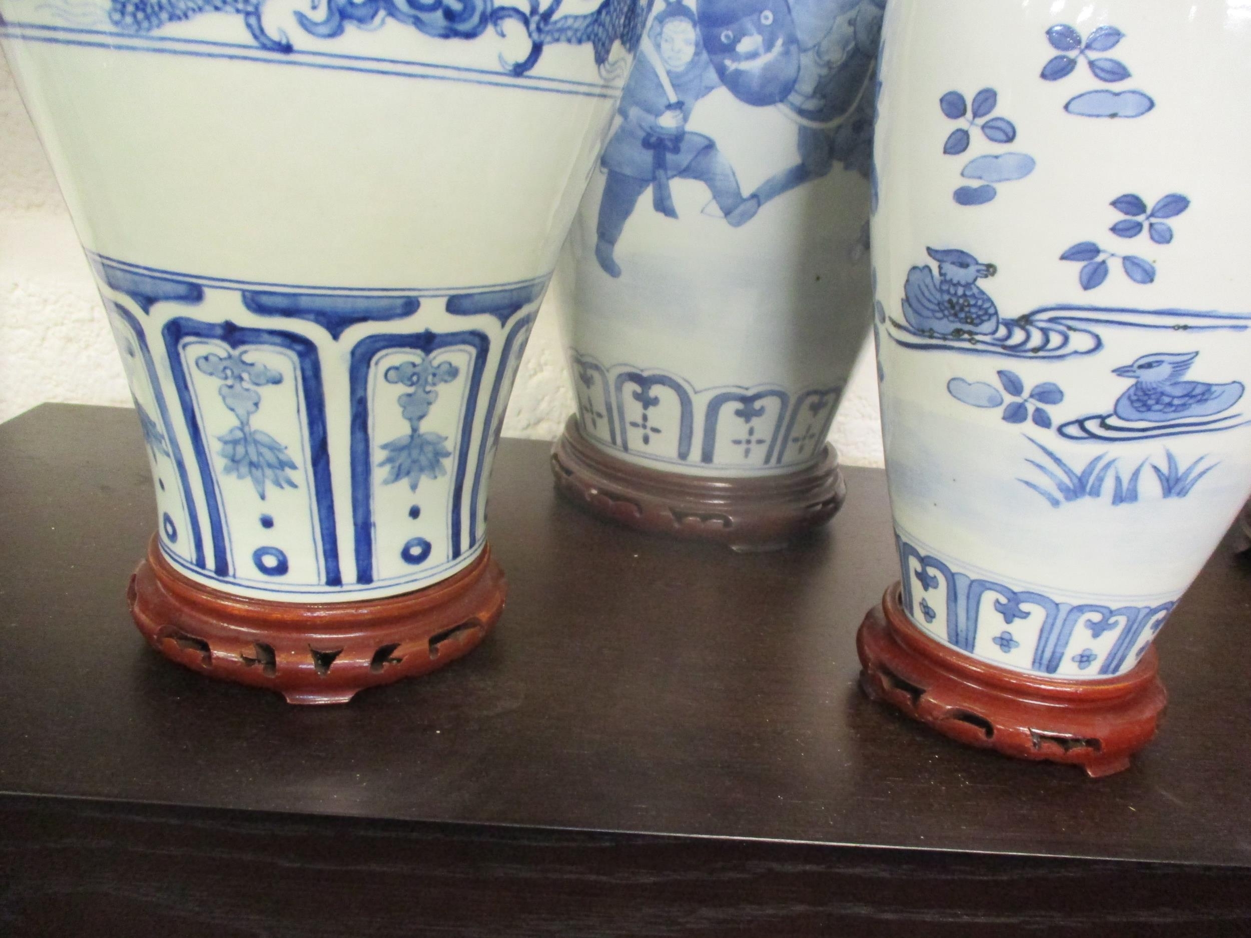 A group of three 20th century Chinese blue and white vases in varying sizes and colours, the tallest - Image 9 of 9