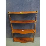 An early 19th century mahogany serpentine front three tier hanging shelf 68cm h x 55cm w Location: