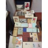A mixed lot to include early 20th century and later postcards housed in a wooden box to include