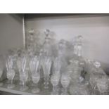 A quantity of pressed and cut glass decanters and liqueur decanters together with French Champagne