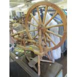 A reproduction beech spinning wheel