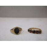 A 9ct gold ring set with five graduated garnets, circa 1970, and a 9ct gold and black onyx plaque