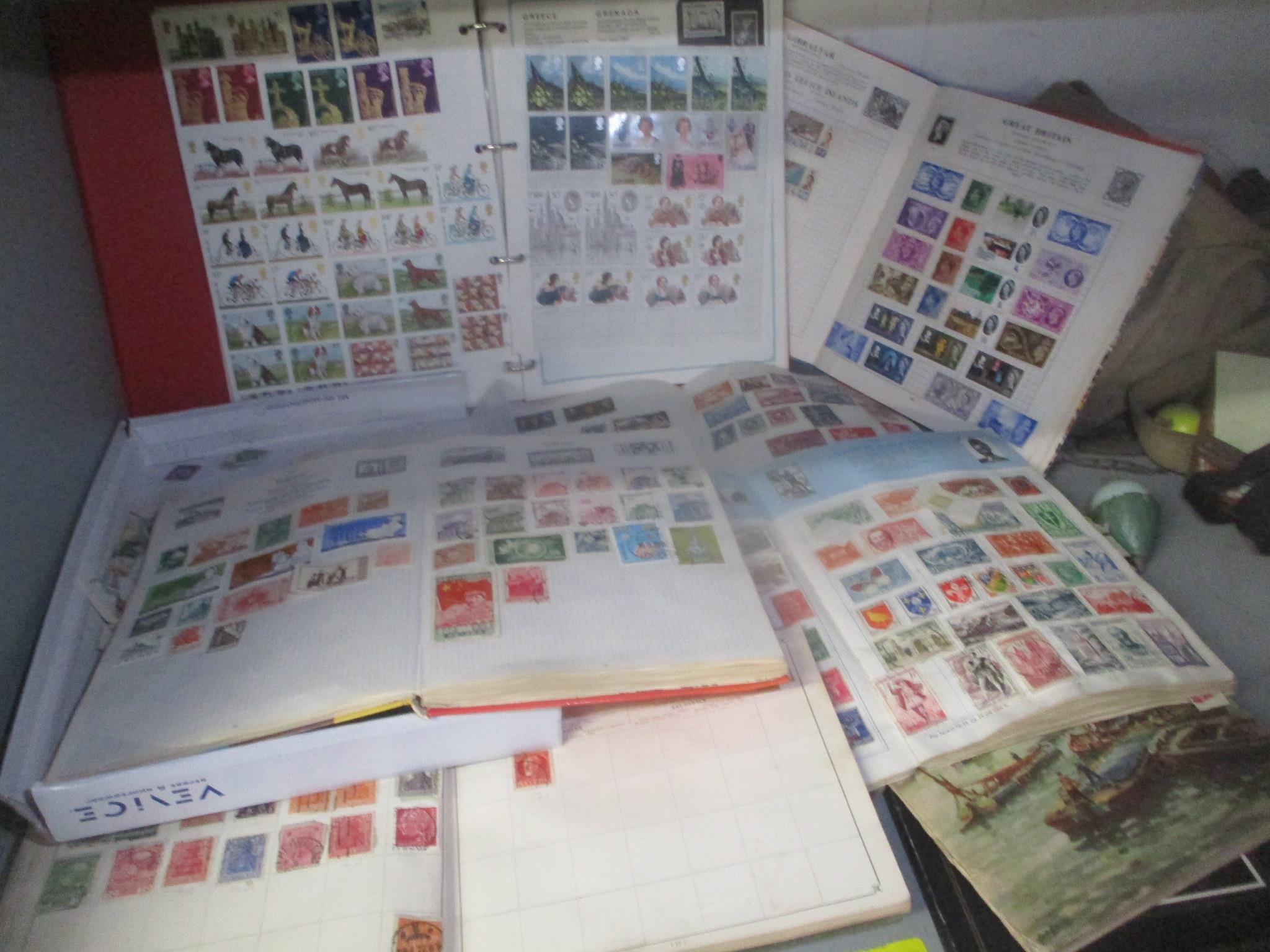 A selection of mixed stamps from around the world contained in albums and loose