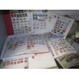 A selection of mixed stamps from around the world contained in albums and loose