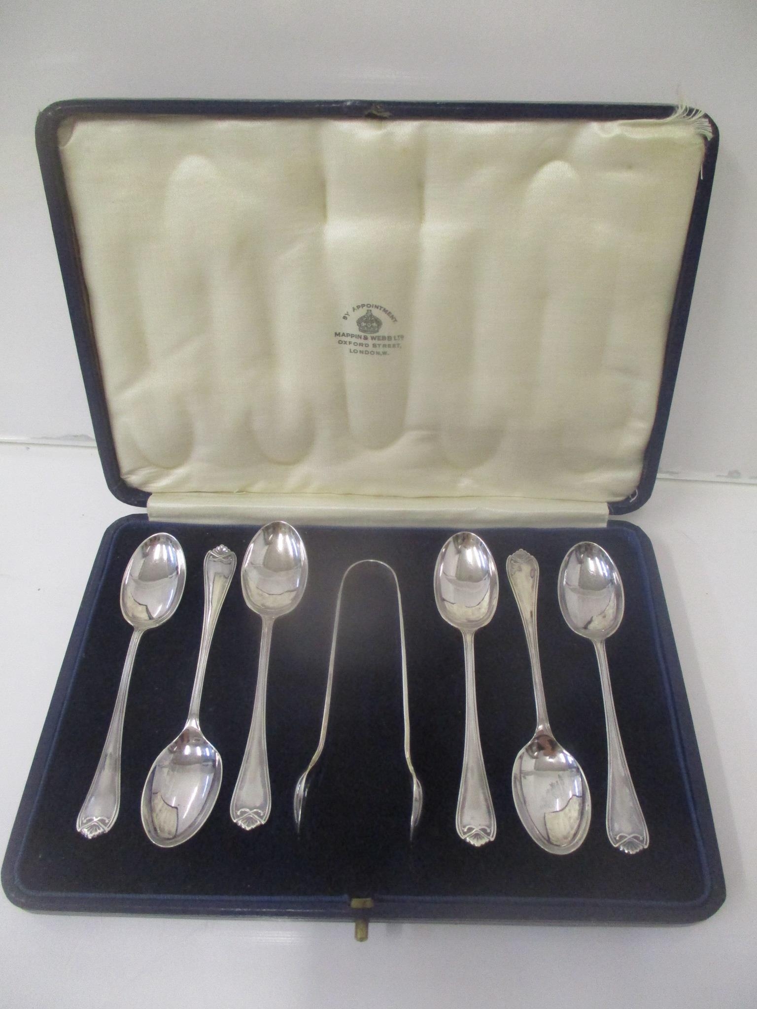 A set of six Mappin & Webb silver teaspoons and matching sugar tongs in a blue leather clad case