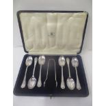 A set of six Mappin & Webb silver teaspoons and matching sugar tongs in a blue leather clad case