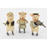 A Schuco three piece 'Pig Band' comprising of a violinist, drummer and a flute player Condition:
