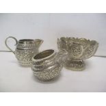 Indian silver with embossed and chased ornament comprising a bowl, a salt and a jug, 30.6g