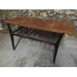 A 1970's retro Nathan teak topped coffee table having ebonised legs and railed magazine tier, 43.5cm