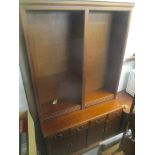A reproduction mahogany bookcase having open shelves above four drawers and cupboard doors below,