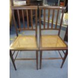 A pair of Edwardian mahogany inlaid occasional chairs with cane seats Location: Row 2