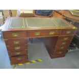 A reproduction mahogany military style twin pedestal desk having a green leather topped scriber
