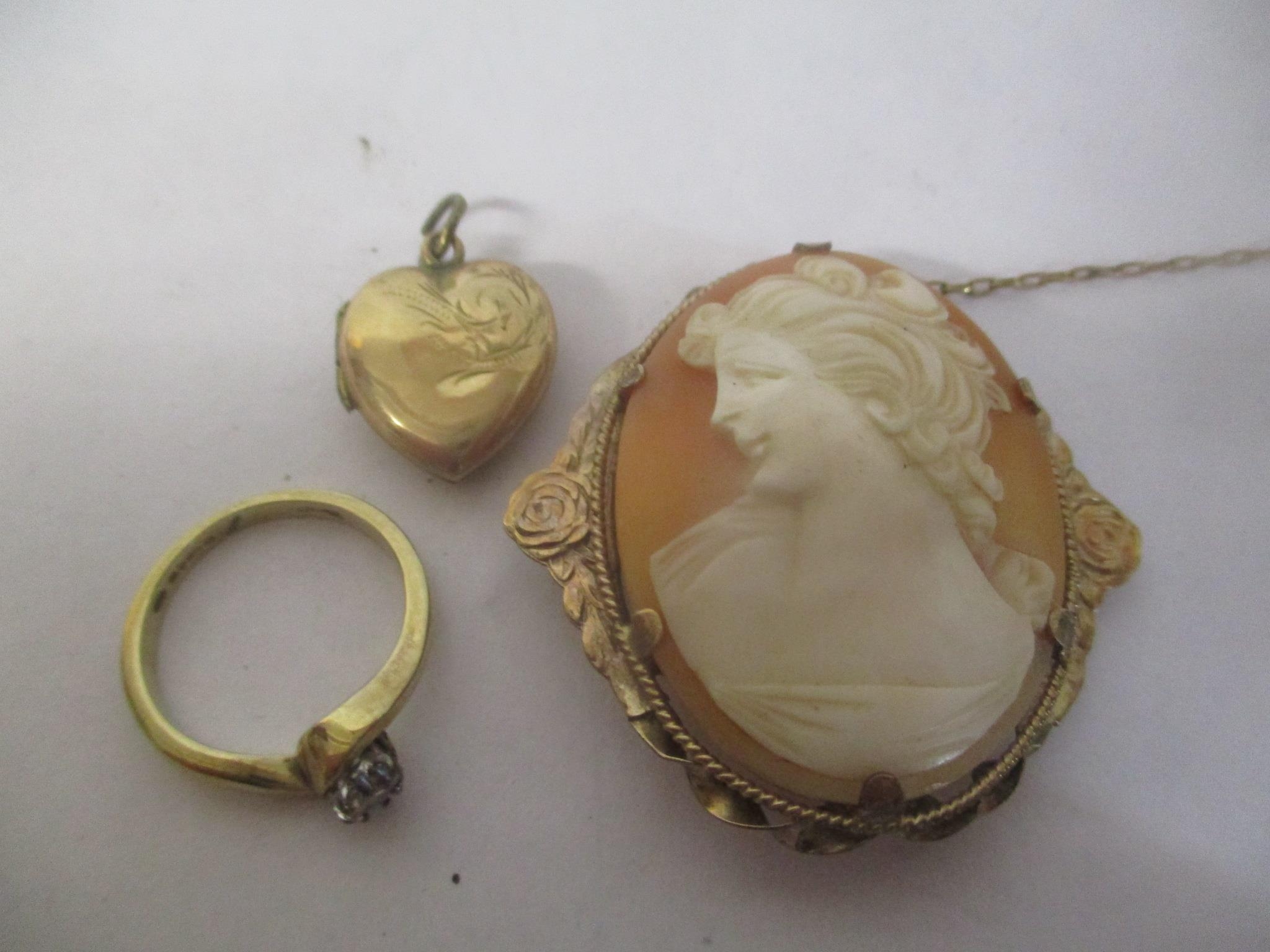 A 9ct gold diamond inset ring 2.5g, together with a cameo brooch, and a 9ct front and back locket