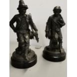 A pair of late 19th/early 20th century French spelter figures of street performers, 35cm high