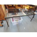 A contemporary wrought iron and glass top coffee table, 46 h x 120 w x 80cm d Location: A2