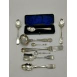 Silver to include two Georgian teaspoons, Victorian tea strainer, Victorian fork, Victorian spoon