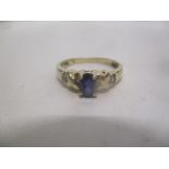 A 9ct gold ring set with a sapphire and two diamonds, 2.1g