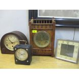 An oak cased mantel clock with galleried top, brass Roman dial, movement striking on a gong with key