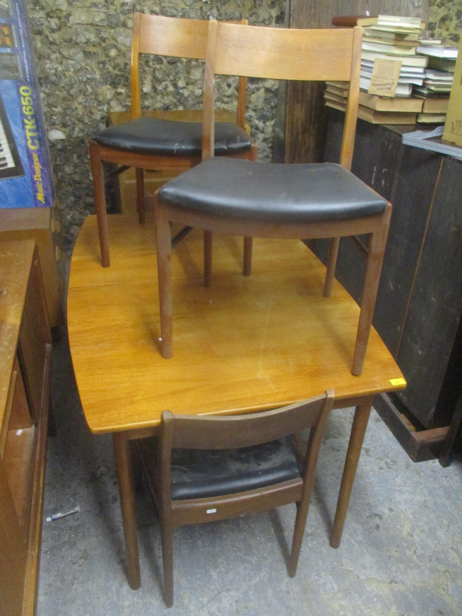 A mid 20th century retro teak extending dining table together with four matching chairs, 74cm h x