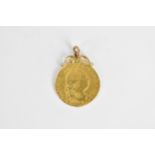 A George III Fourth Head, crowned shield forms 1786 half guinea with attached loop to be worn as