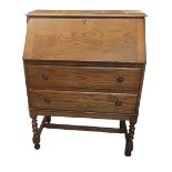 An early 20th century oak bureau fall flap above two drawers and barley twist supports, 98cm h x