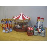 Four Christmas carousel items to include a merry go round with horses, polar bears and tigers