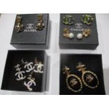 A small quantity of modern earrings in the style of a well known fashion house, with related boxes