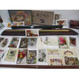 A mixed lot to include an International Glide snooker cue, early 20th century postcards, a Roamer