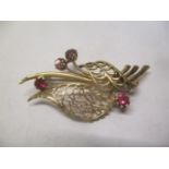 A 9ct gold brooch inset with four rubies 5.5g