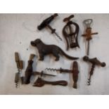 Eight vintage corkscrews together with a cast iron nut cracker in the form of a dog, Location RWF