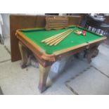 An early 20th century oak Riley snooker table converting to a dining table with scoreboard and