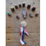 Eight thimbles to include silver and enamelled examples together with. a white metal pin cushion