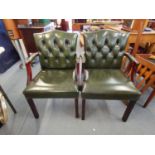 A pair of 20th century Gainsborough style armchairs with green leather button back upholstery