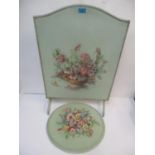 A 1930s floral embossed and painted fire screen and matching plaque