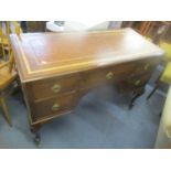 An early 20th century mahogany desk with five drawers, on cabriole legs and castors, 80cm h x 114.