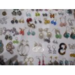 A large quantity of pierced earrings to include silver, silver gilt and hardstone examples