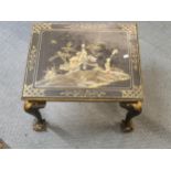 A 1920s chinoiserie black lacquered table, raised on cabriole and ball and claw feet, 41cm h, 52cm