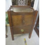 A Georgian mahogany commode with two doors with slide out drawer below