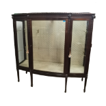 A good quality 1920s mahogany display cabinet having a stepped cornice with rans head below and