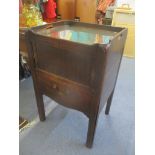 A Georgian mahogany commode having a tambour sliding door above pull out drawer below