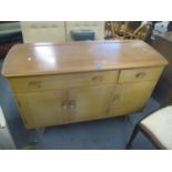 An Ercol two tone elm sideboard with two drawers and three doors, on turned, tapered legs, 80cm h