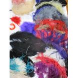 A quantity of colourful ostrich feathers, mainly hat accessories to include a faux blackbird and