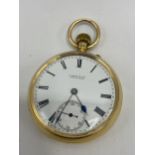 An early 20th century 18ct gold open faced keyless lever pocket watch, the white enamel dial