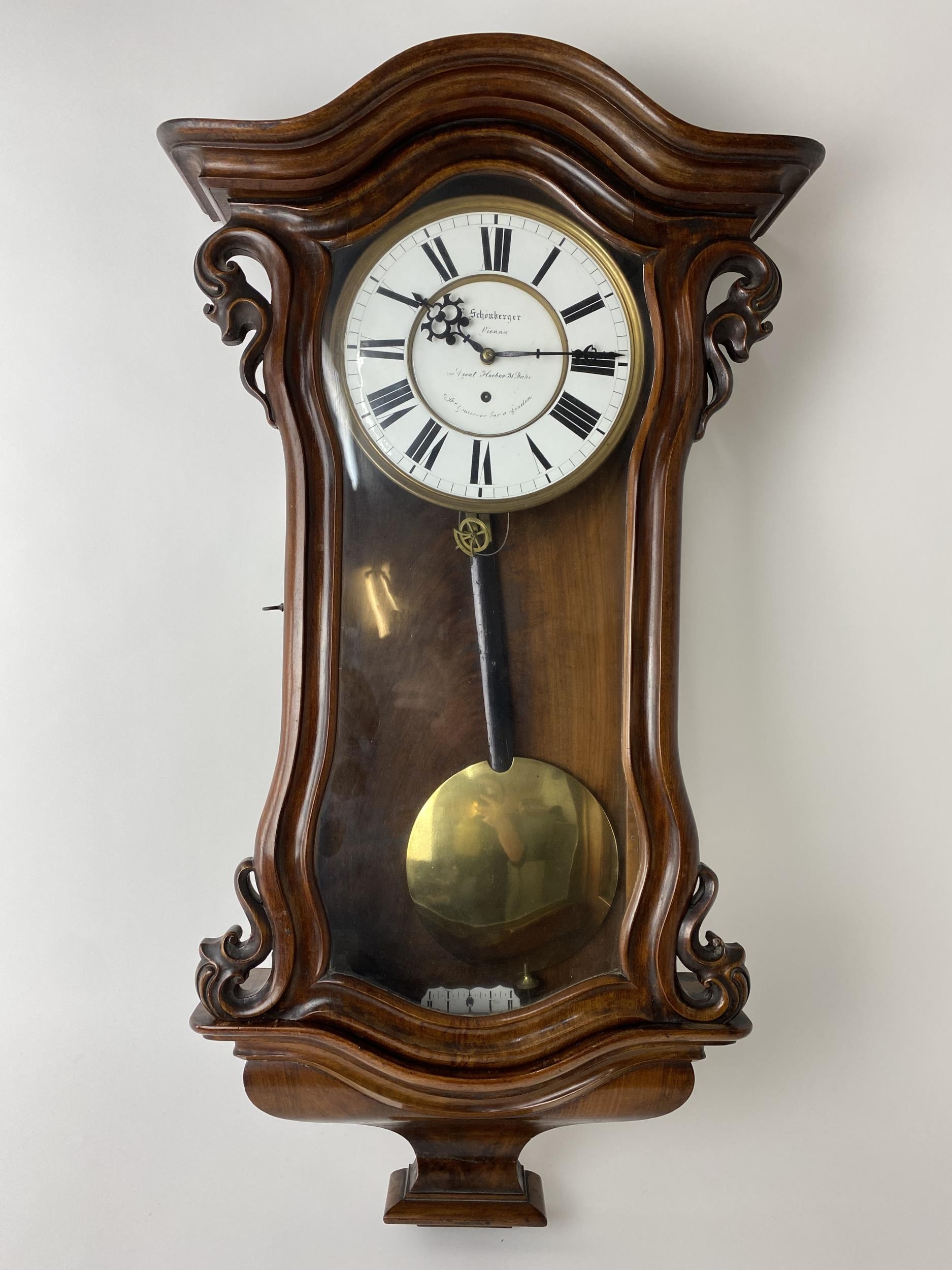 A late 19th century walnut 8 day Vienna regulator wall clock, the circular dial having black Roman