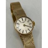 A Tissot ladies 9ct yellow gold manual wind wristwatch, the silvered dial having baton markers and