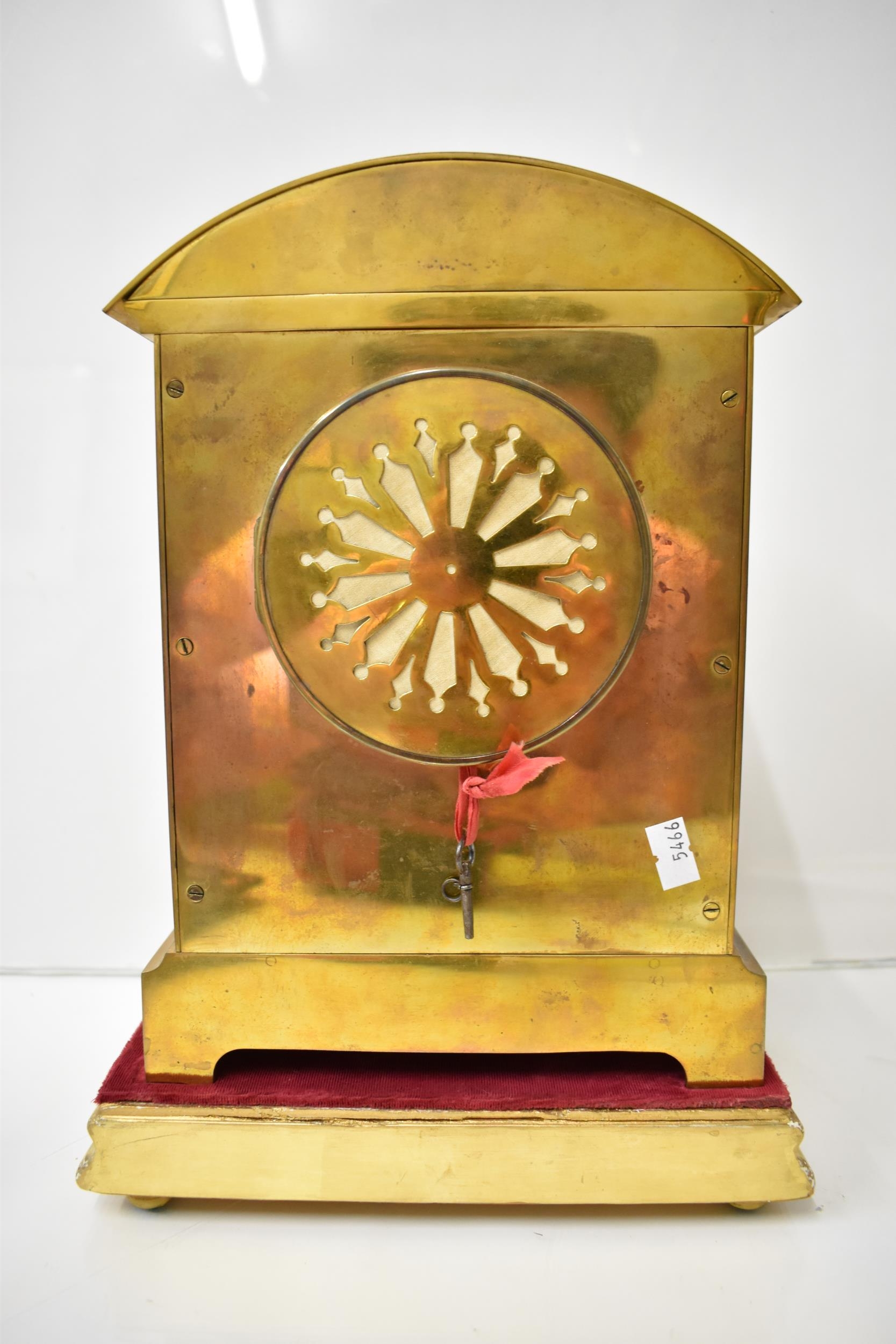 An early 20th century brass mantle clock on a gilded treen stand, the arched top case with floral - Image 3 of 5