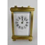 A late 19th/early 20th century brass cased repeater carriage clock having a white enamel dial with